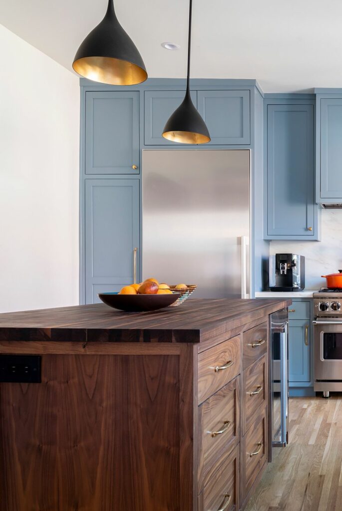 Rustic kitchen showroom with blue cabinetry